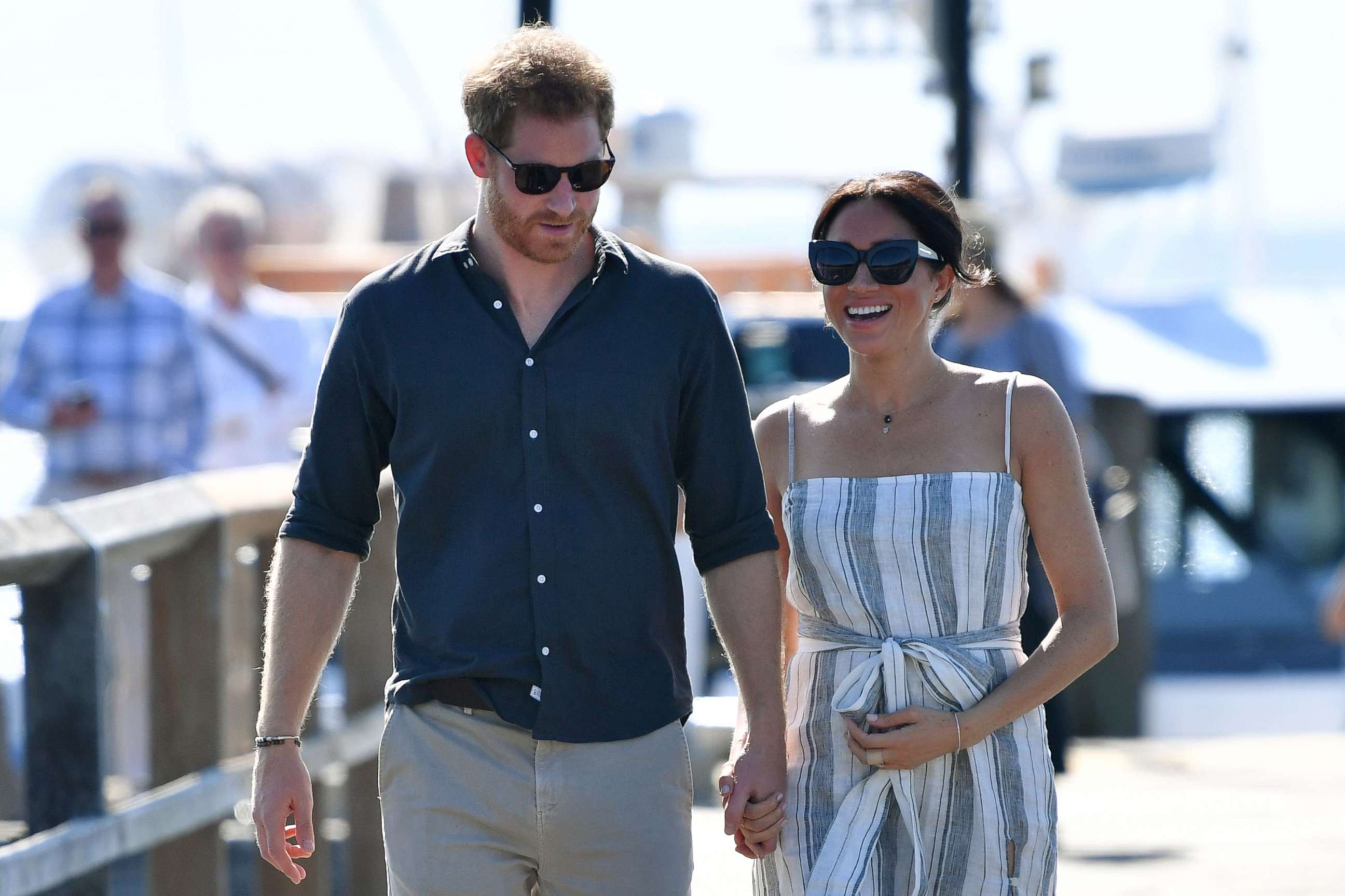 PHOTO: Britain's Prince Harry and his wife Meghan, the Duchess of Sussex walk to attend a meet-the-people session at Kingfisher Bay Resort on Fraser Island, Oct. 22, 2018.