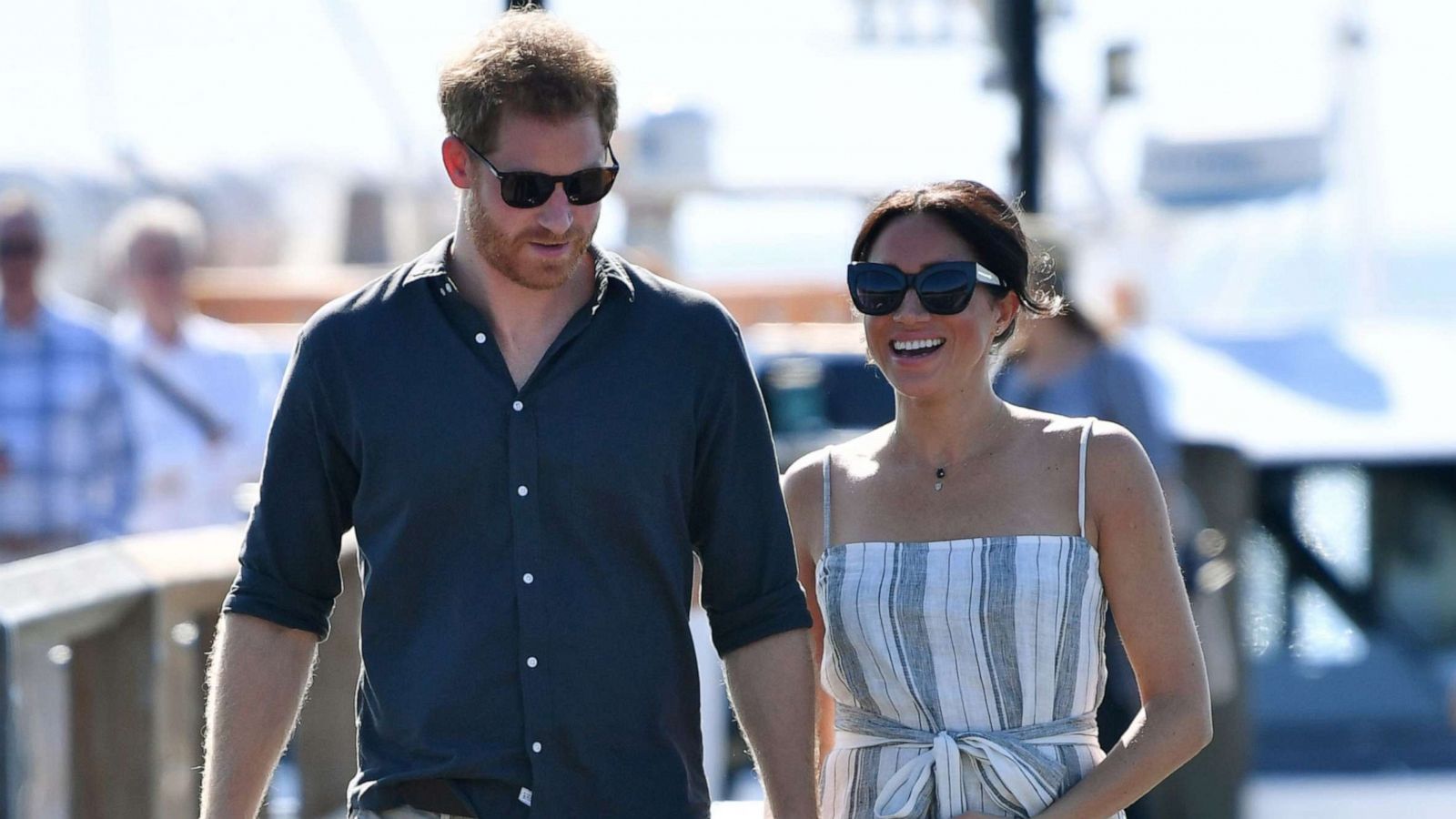 PHOTO: Britain's Prince Harry and his wife Meghan, the Duchess of Sussex walk to attend a meet-the-people session at Kingfisher Bay Resort on Fraser Island, Oct. 22, 2018.