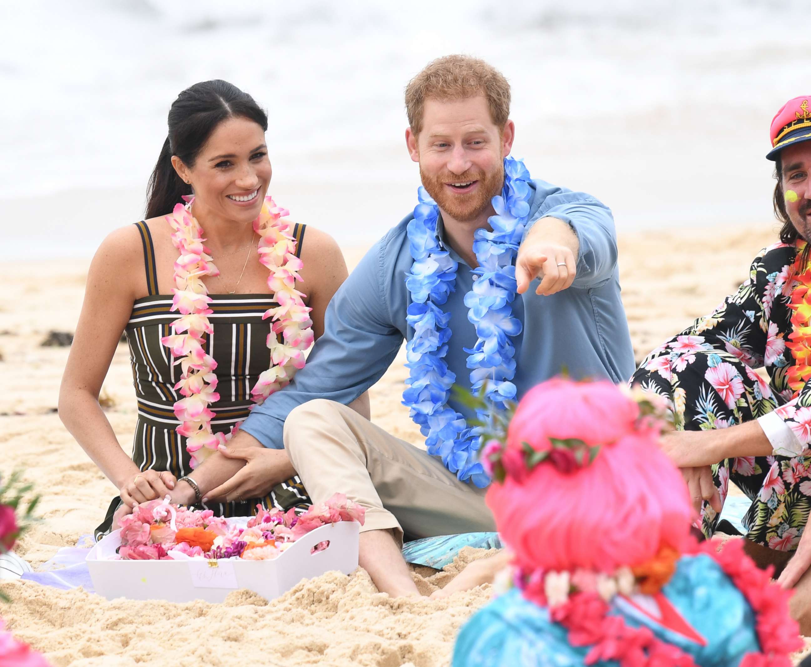 PHOTO: Meghan and Prince Harry talk to members of OneWave, an awareness group for mental health and well-being at South Bondi Beach, Oct. 19, 2018, in Sydney, Australia. 