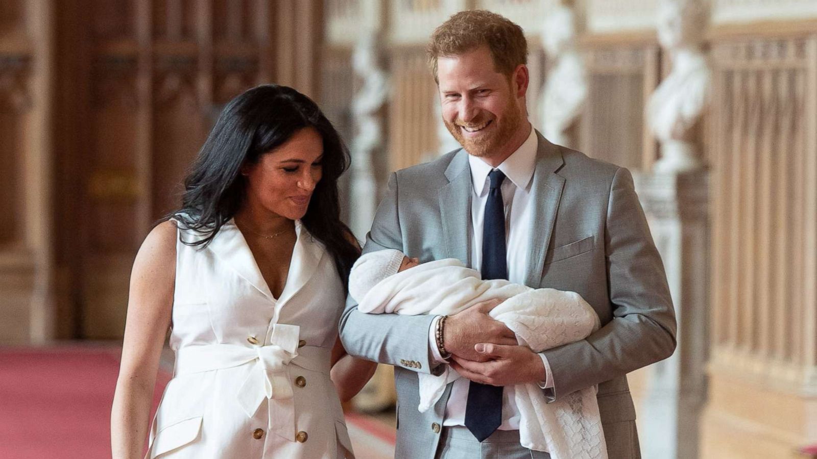 PHOTO: Britain's Prince Harry, Duke of Sussex and his wife Meghan, Duchess of Sussex, carry their newborn baby son in St George's Hall at Windsor Castle in Windsor, England, May 8, 2019.