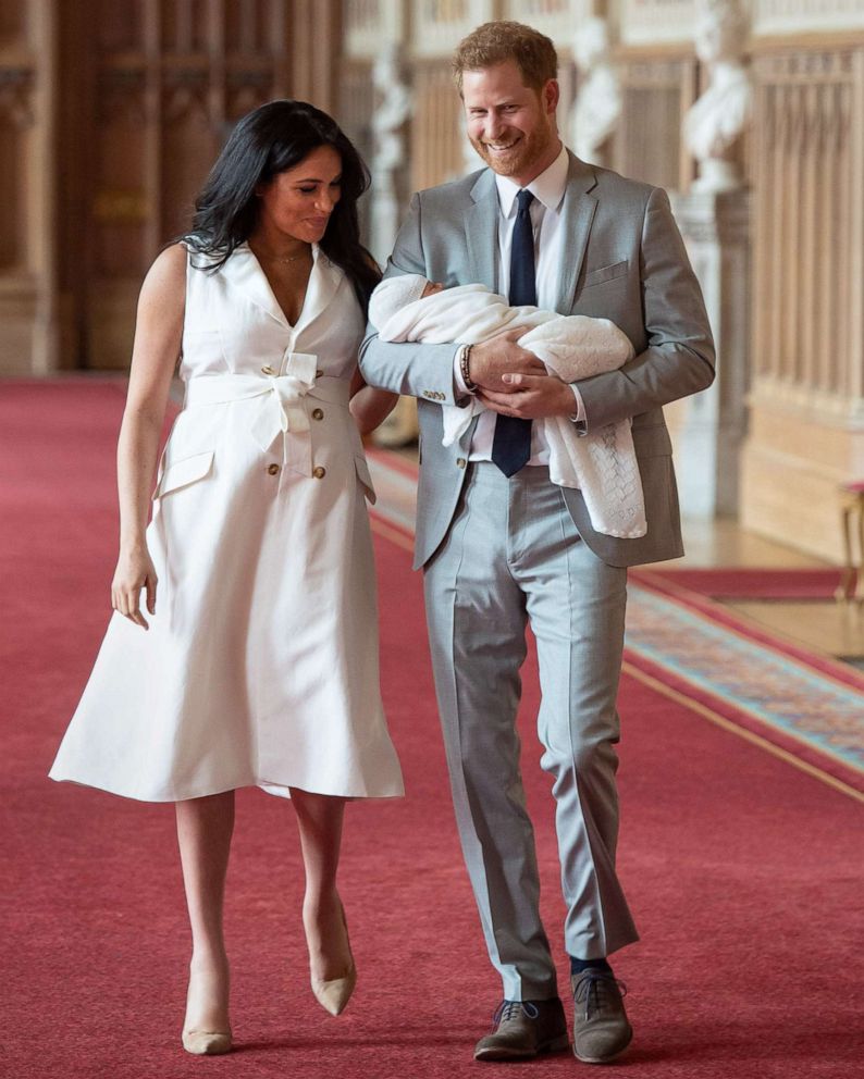 PHOTO: Britain's Prince Harry, Duke of Sussex and his wife Meghan, Duchess of Sussex, carry their newborn baby son in St George's Hall at Windsor Castle in Windsor, England, May 8, 2019.