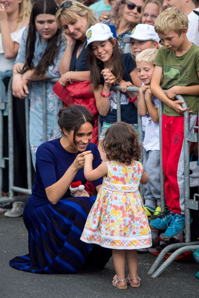 PHOTO: Megan, Duchess of Sussex holds hands with a young girl during a walkabout on day four of the royal couple's tour of New Zealand, Oct. 31, 2018, in Rotorua, New Zealand.