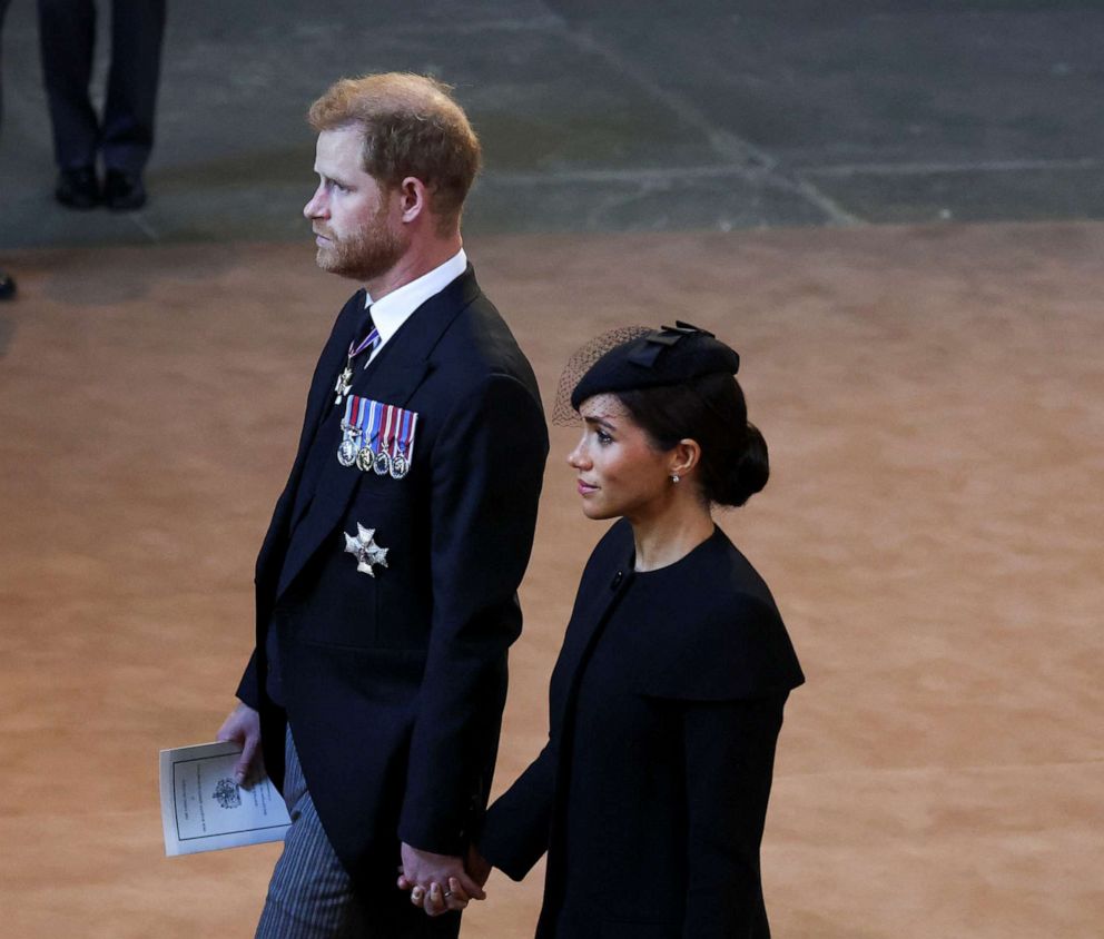 PHOTO: Prince Harry and Meghan, Duchess of Sussex walk as procession with the coffin of Queen Elizabeth arrives at Westminster Hall from Buckingham Palace for her lying in state on Sept. 14, 2022 in London.