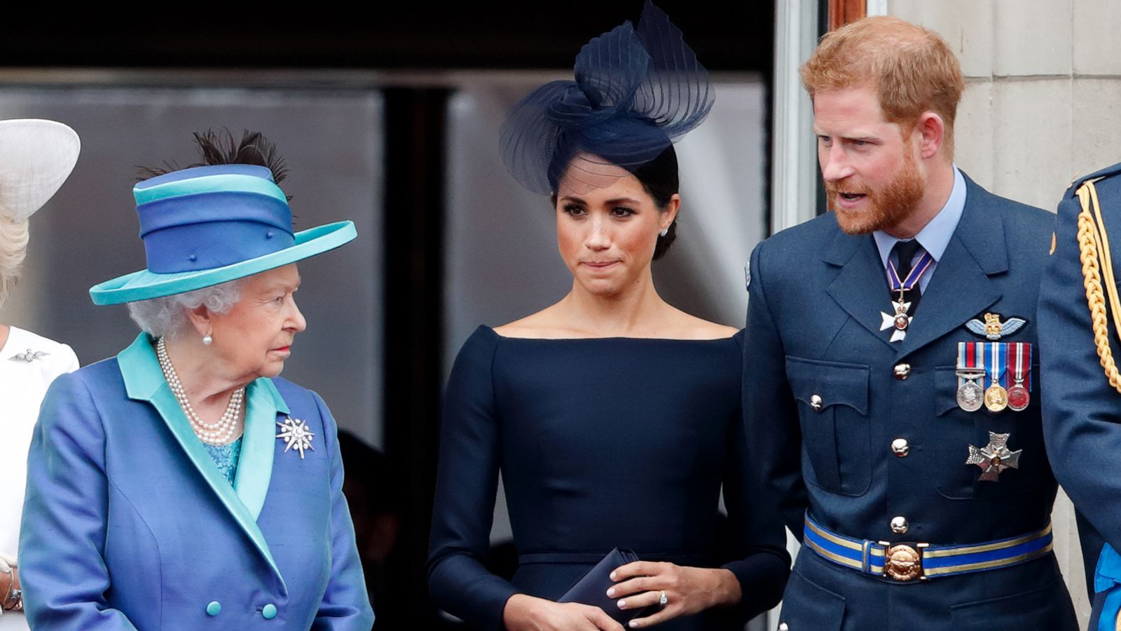 PHOTO: Queen Elizabeth II, Meghan, Duchess of Sussex and Prince Harry, Duke of Sussex watch a flypast to mark the centenary of the Royal Air Force from the balcony of Buckingham Palace on July 10, 2018 in London.