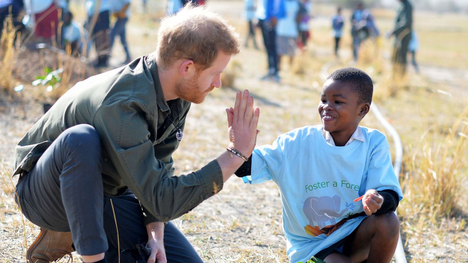 PHOTO:Britain's Prince Harry, Duke of Sussex gives a high five to a child as he joins school children in a tree planting event in Chobe National Park, Kasane, Botswana, Sept. 26, 2019.