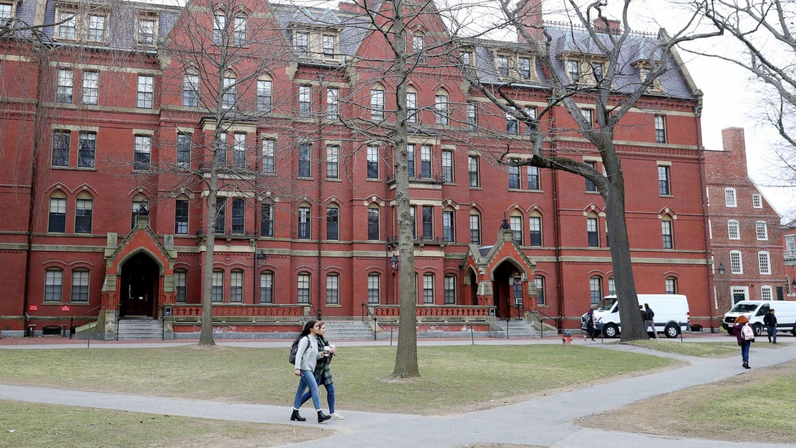 PHOTO: Students walk through Harvard Yard on the campus of Harvard University on March 12, 2020 in Cambridge, Mass.