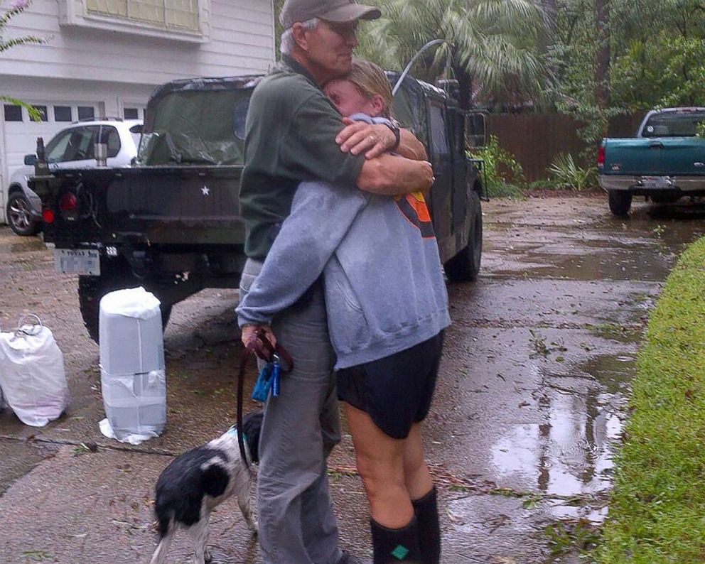 PHOTO: Jane Henry hugs her father after Hurricane Harvey destroyed her home. 