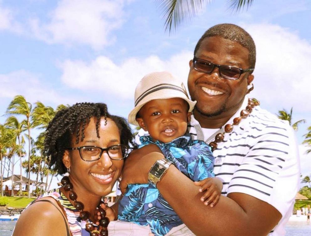 PHOTO: Jordanne and Cedric Wells hold their oldest child during a trip to Hawaii in 2015.