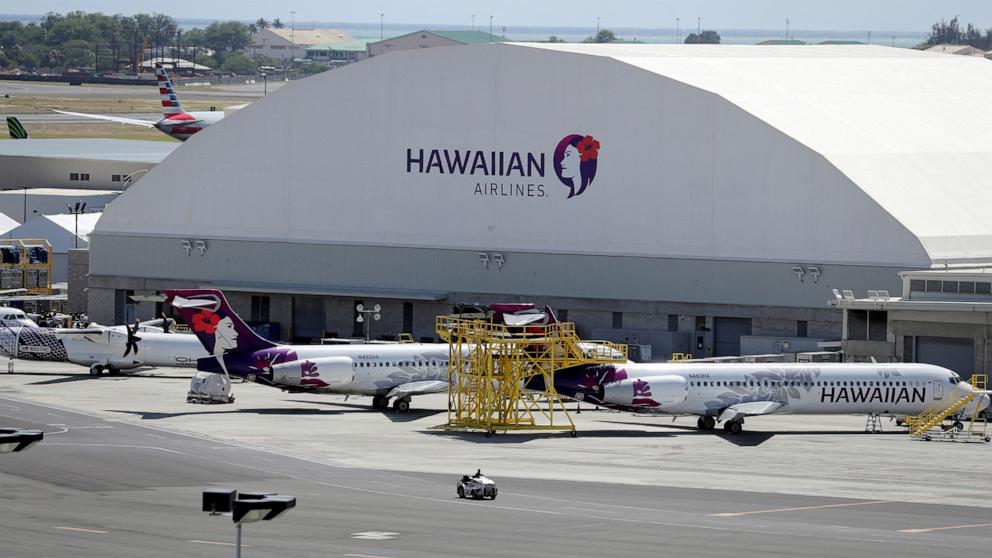 PHOTO: In this April 28, 2020 file photo, Hawaiian Airlines airplanes sit idle on the runway at the Daniel K. Inouye International Airport in Honolulu.