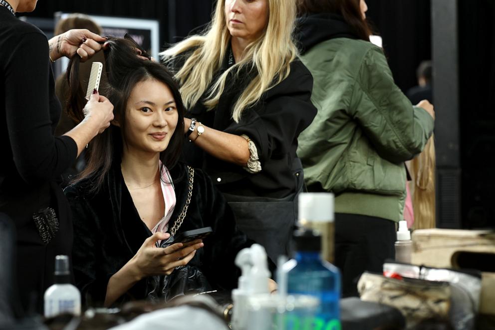 PHOTO: He Cong prepares backstage at the Victoria's Secret Fashion Show 2024 on Oct. 15, 2024,in New York.