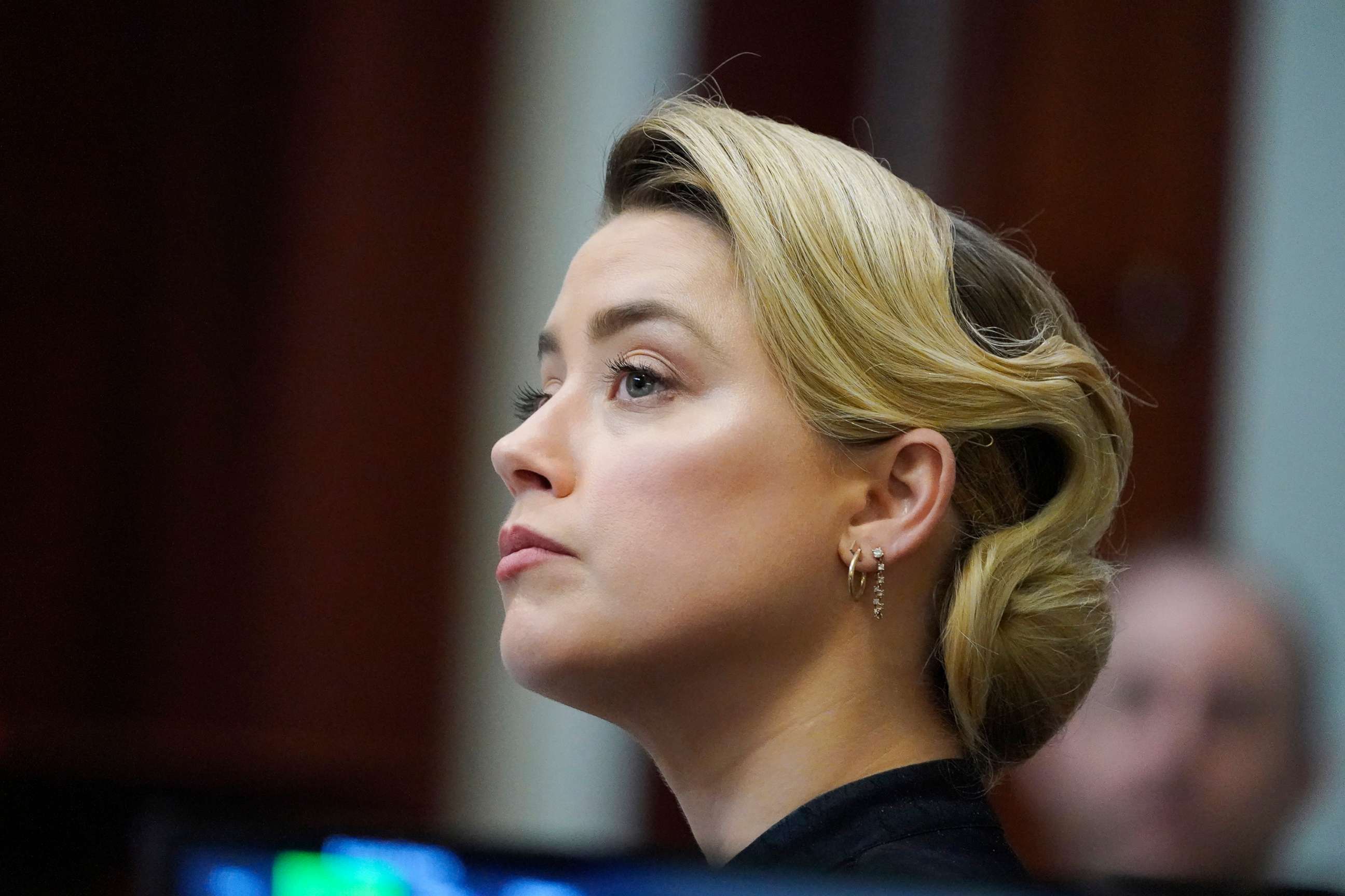 PHOTO: Actress Amber Heard listens in the courtroom at the Fairfax County Circuit Courthouse in Fairfax, Va., April 25, 2022. 
