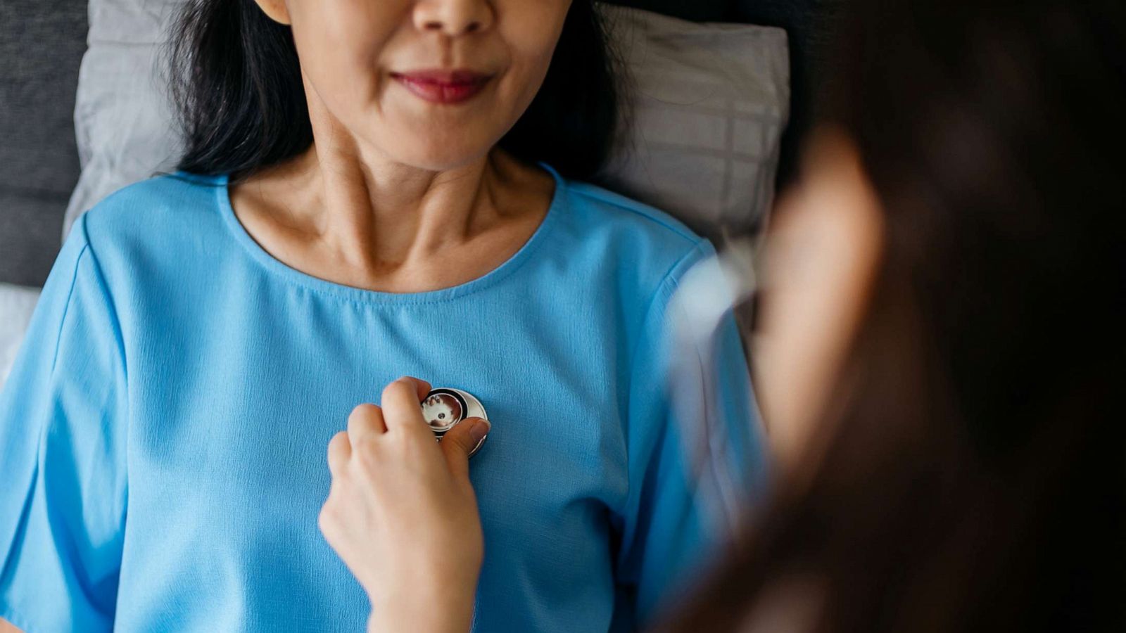 PHOTO: A doctor listens to a woman's heart with a stethoscope in this stock photo.