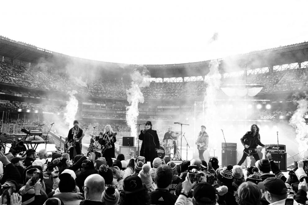 PHOTO: Heart appears in this black and white image of them performing on stage in front of a crowd of people.