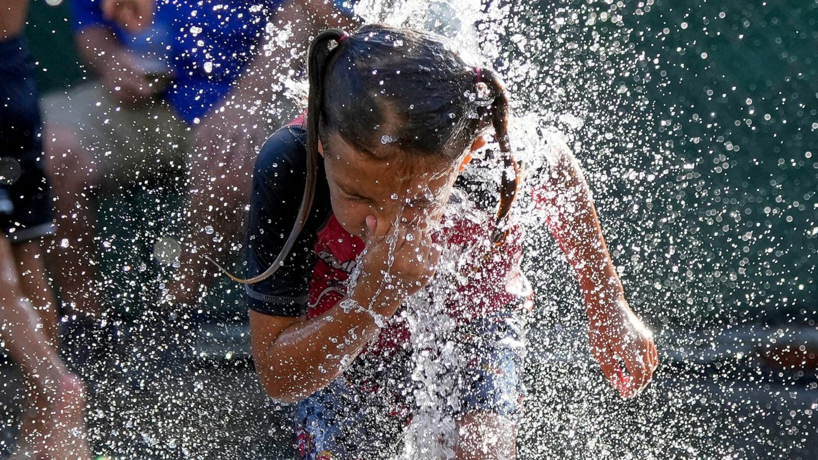 PHOTO: A child cools off in a fountain during hot weather in Chicago, June 29, 2026.