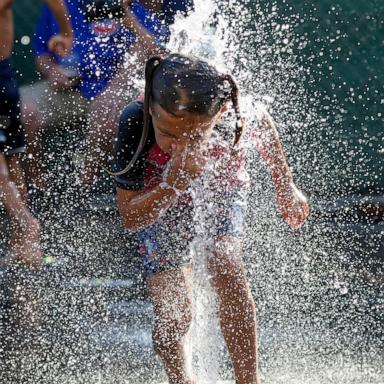 PHOTO: A child cools off in a fountain during hot weather in Chicago, June 29, 2026.