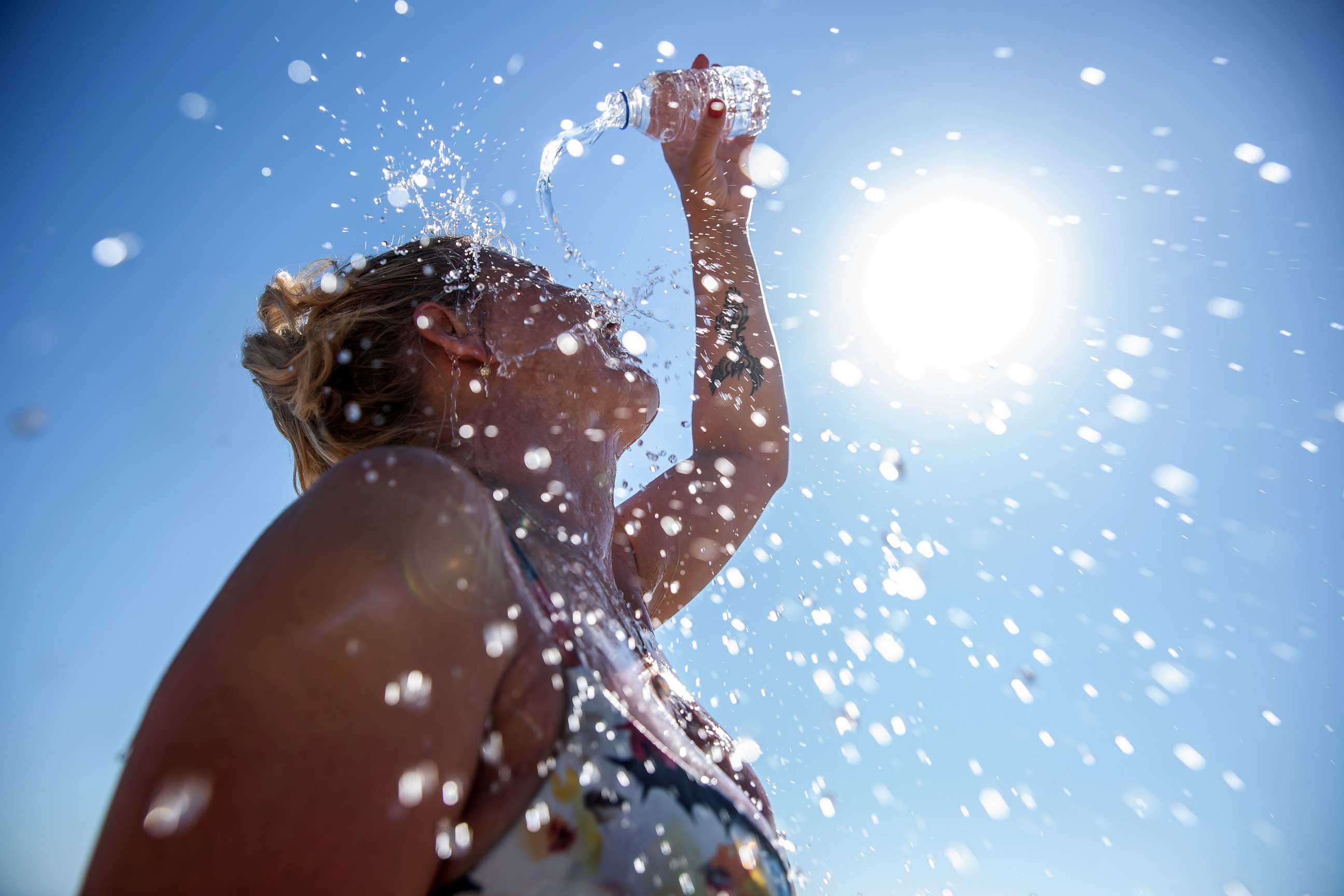 PHOTO: Stock photo of a woman cooling off with water.