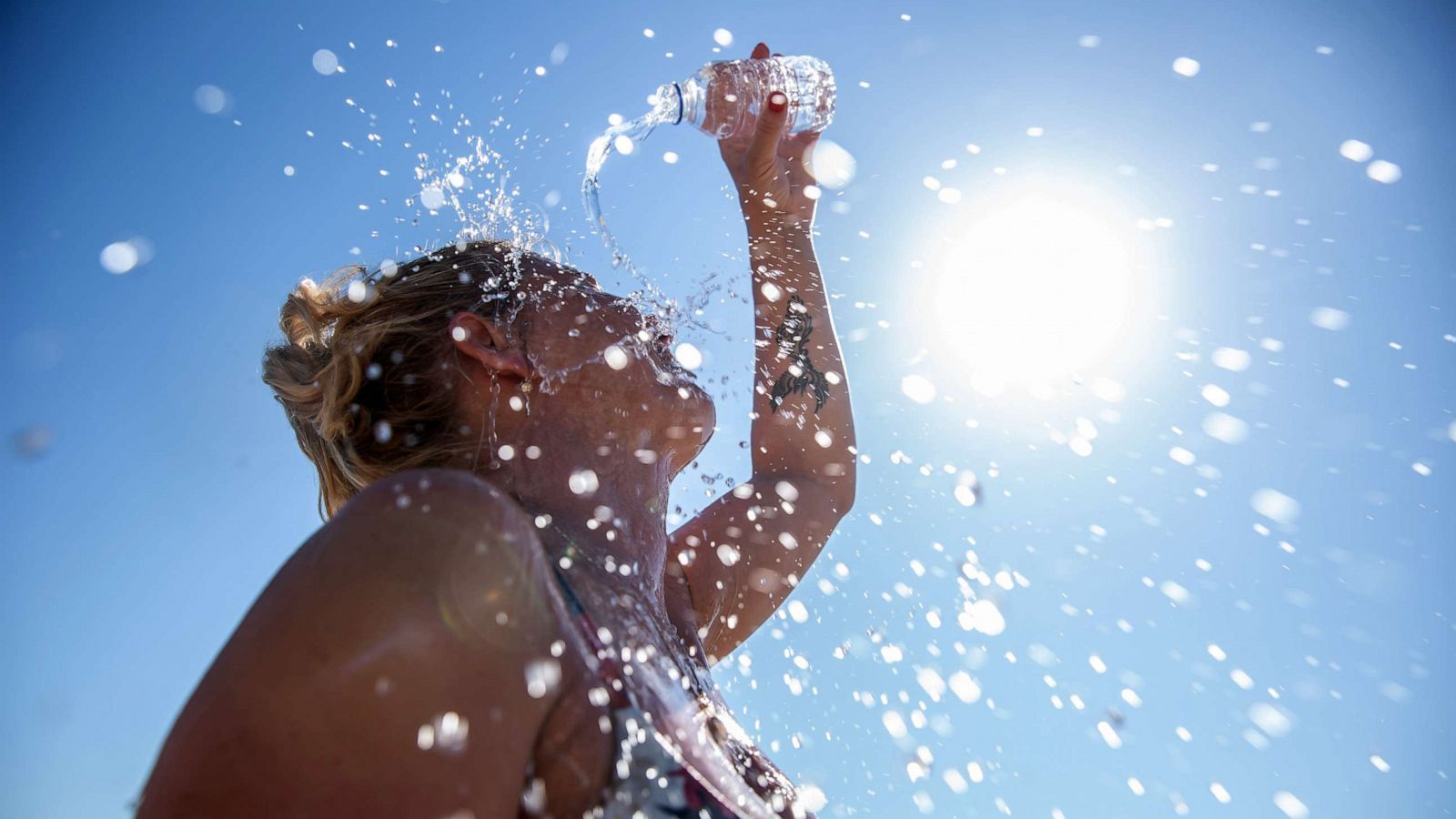 PHOTO: Stock photo of a woman cooling off with water.