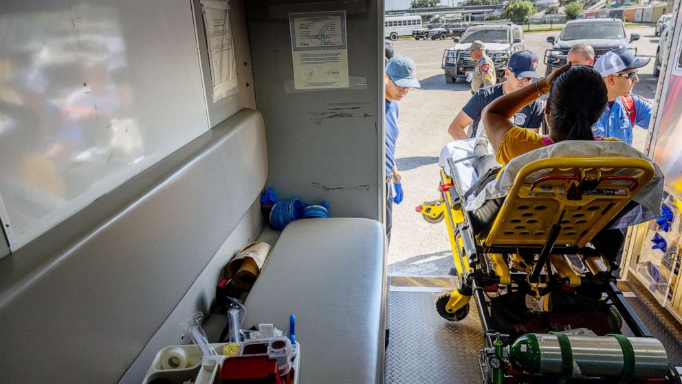 PHOTO: Eagle Pass Station 1 emergency medical technicians respond to a pregnant woman suffering from dehydration on July 19, 2023 in Eagle Pass, Texas.
