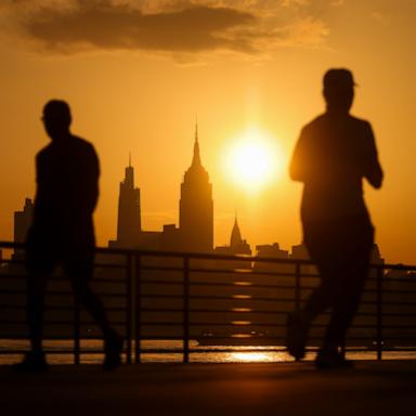 PHOTO: The sun rises behind the Manhattan skyline during high temperatures in Jersey City, N.J, July 2, 2026. 
