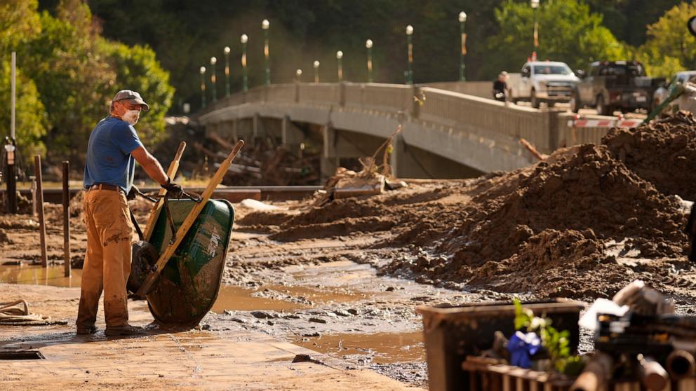 PHOTO: Brian McCormack pauses after using a wheelbarrow to clean up debris left in the aftermath of Hurricane Helene, Oct. 1, 2024, in Marshall, N.C.