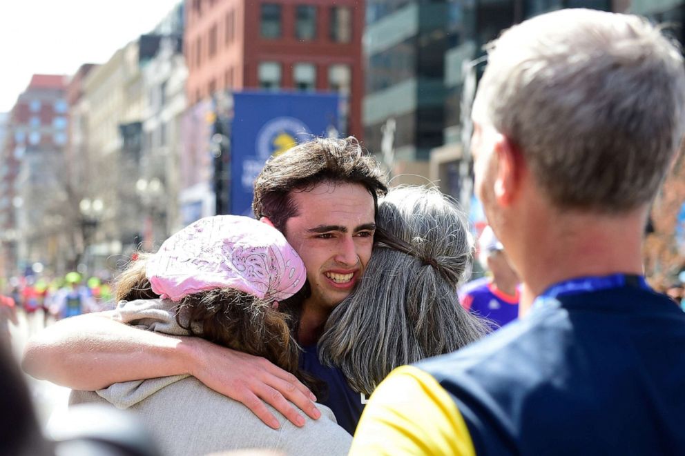 PHOTO: Henry Richard is met by family at the finish line at the 2022 Boston Marathon in Boston, on April 18.