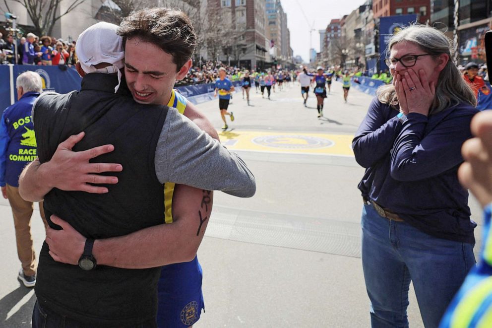 PHOTO: Henry Richard, the brother of 2013 Boston Marathon bombing victim Martin Richard, is hugged by 2014 Boston Marathon champion Meb Keflezighi, as Henry's mother Denise looks on, after finishing the 126th Boston Marathon in Boston,  April 18, 2022.