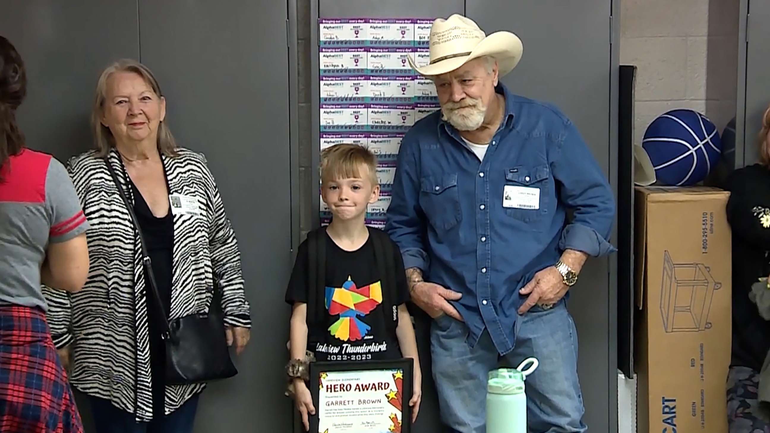 PHOTO: Garrett with his parents at an assembly at Lakeview Elementary School where he was presented with a "hero award" for helping to save a choking classmate, in Norman, Okla.