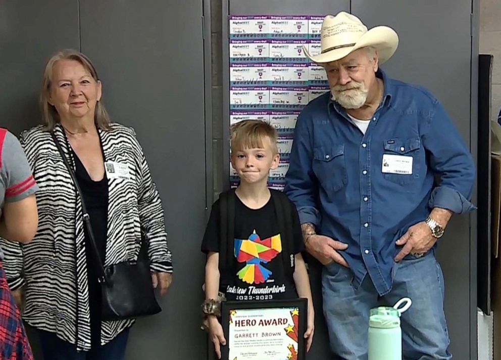 PHOTO: Garrett with his parents at an assembly at Lakeview Elementary School where he was presented with a "hero award" for helping to save a choking classmate, in Norman, Okla.