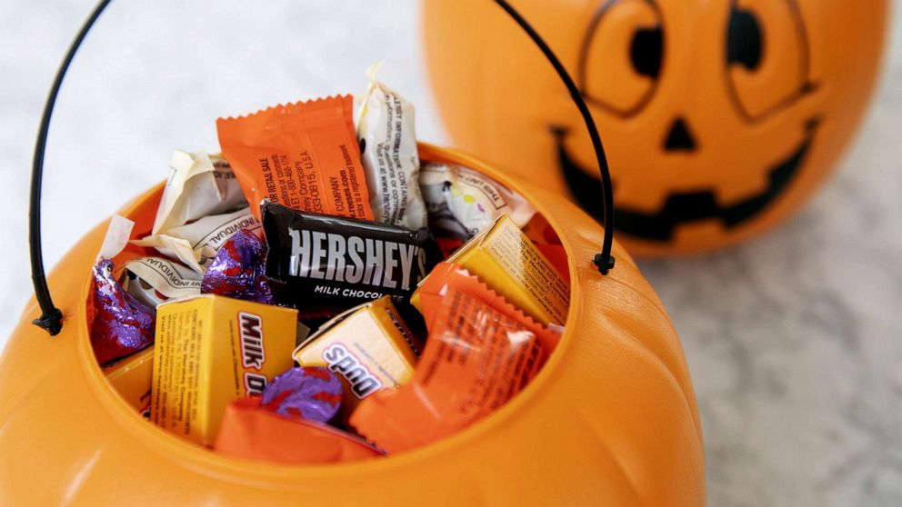 PHOTO: Hershey Co.  brand Halloween candy is displayed inside a pumpkin-themed treat bucket in Tiskilwa, Illinois, Sept.  20, 2020.