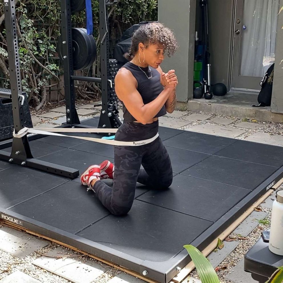 PHOTO: Melissa Alcantara demonstrates a kneeling banded hip thrust.