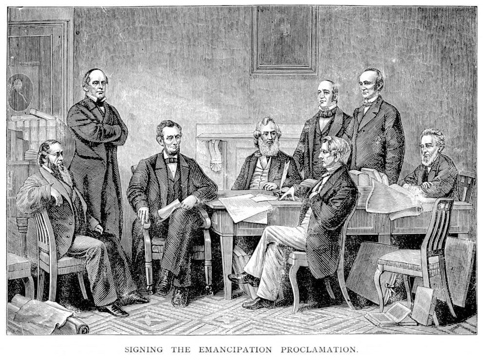 PHOTO: An engraving From 1882 shows Abraham Lincoln Signing The Emancipation Proclamation Which Ended Slavery.