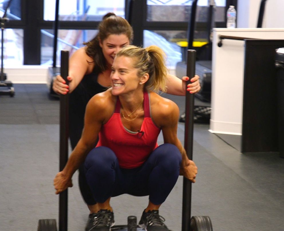 PHOTO: Holly Rilinger, creator of LIFTED, is pushed on a power sled by Julia Dodds.