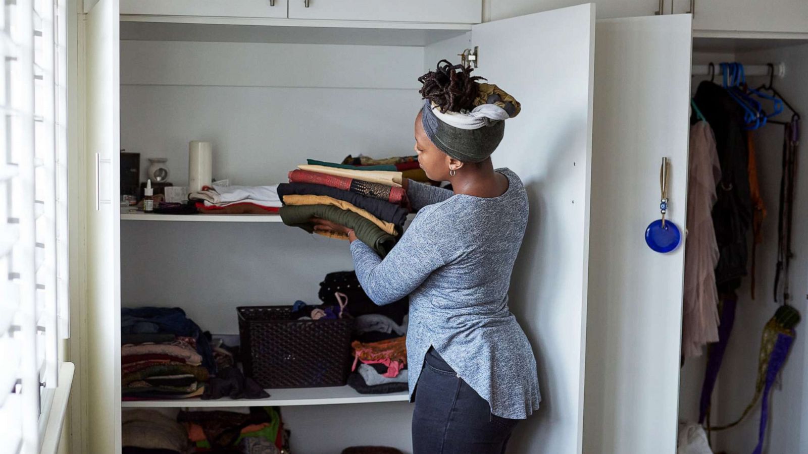 PHOTO: A woman organizes laundry in a closet in an undated stock image.