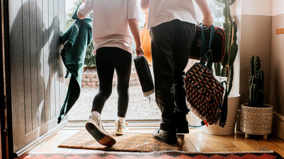 PHOTO: Stock photo of two kids leaving a home. 