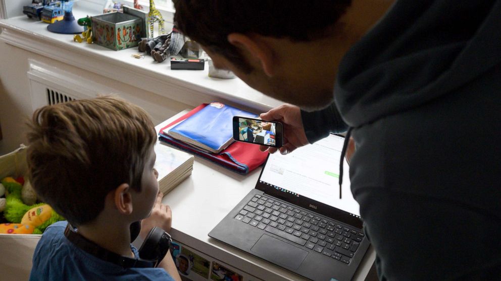 PHOTO: Joachim, 8, whose school was closed following the Coronavirus outbreak, records a message to his classmates on his dad's phone as a part of his homework, March 20, 2020, in Washington, D.C.