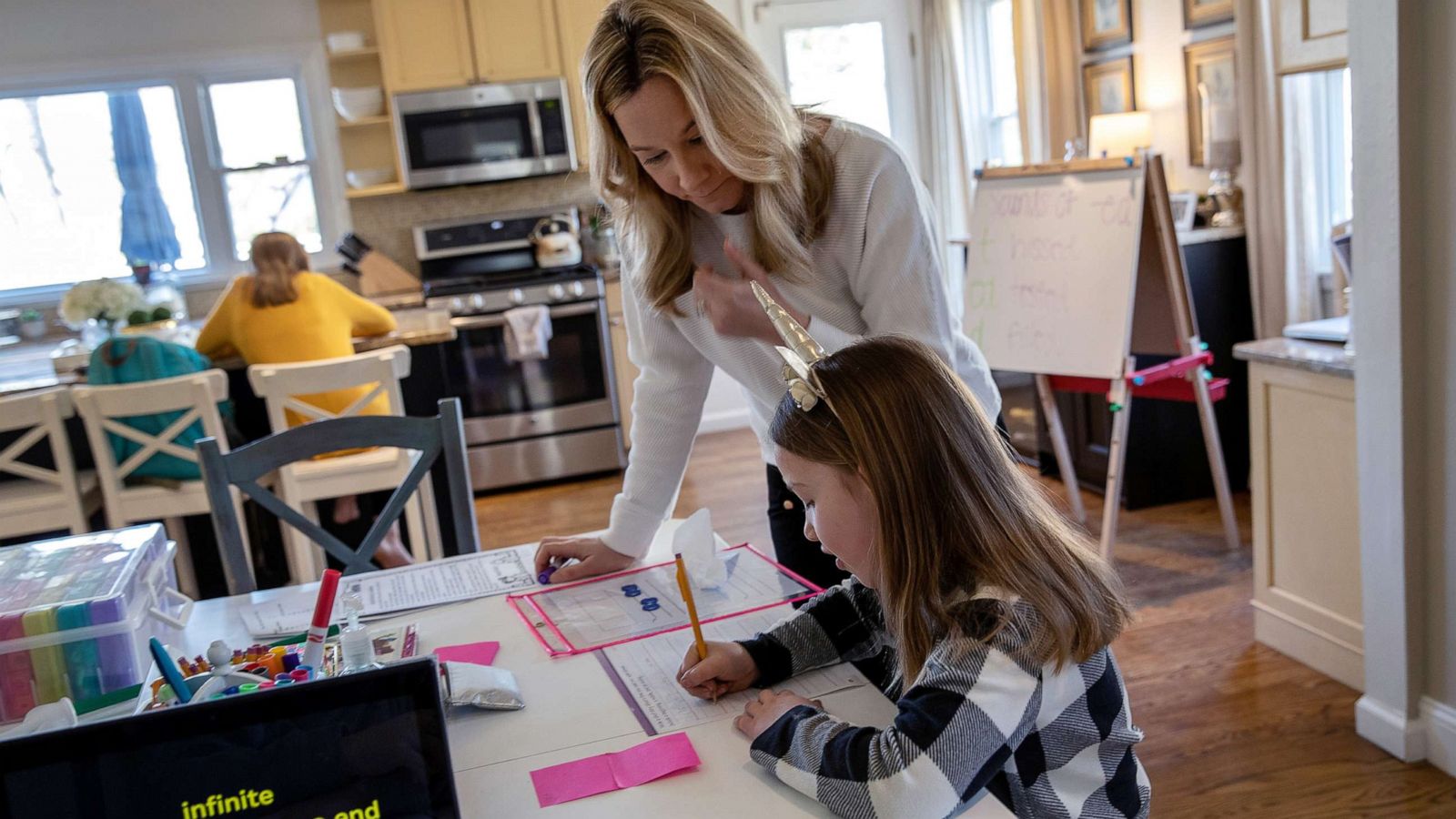 PHOTO: Farrah Eaton assists her daughter Nola, 6, with home schooling on March 18, 2020 in New Rochelle, New York.