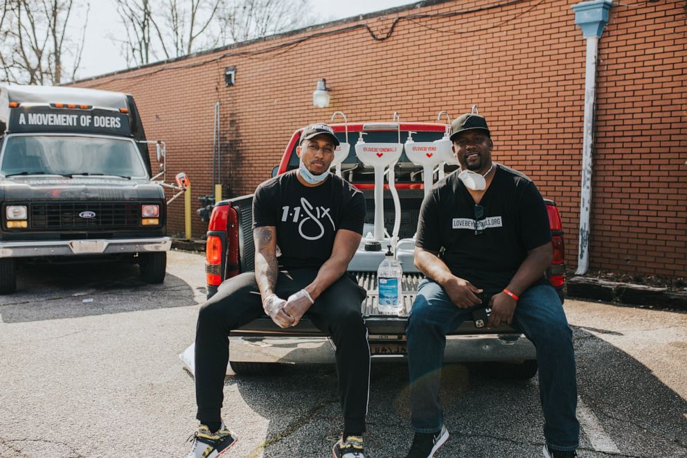 PHOTO: Lecrae, left, and Terence Lester pose after spending the day setting up stations around the city. 