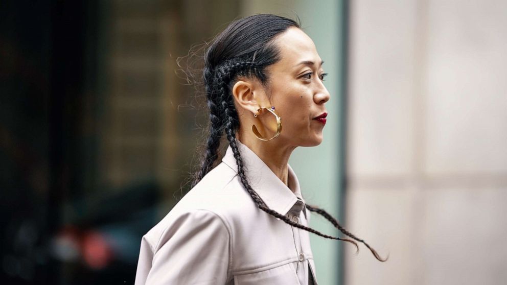 A guest wears earrings, a grey shirt, outside Thom Browne, during Paris Fashion Week Womenswear Fall/Winter 2019/2020, March 3, 2019 in Paris.