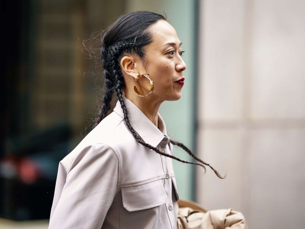 PHOTO: A guest wears earrings, a grey shirt, outside Thom Browne, during Paris Fashion Week Womenswear Fall/Winter 2019/2020, March 3, 2019 in Paris.