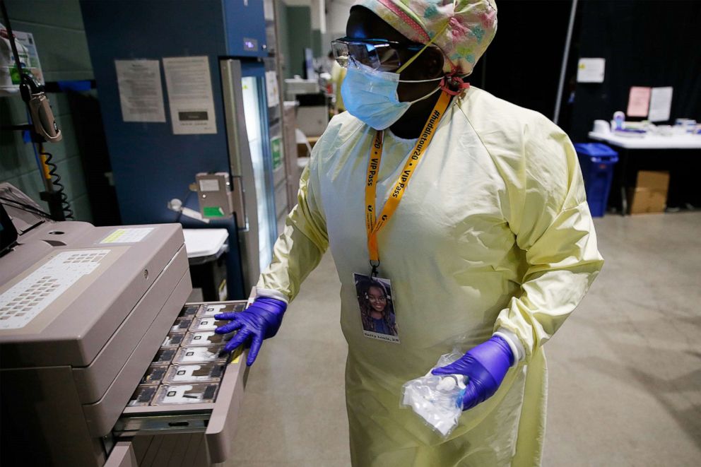 PHOTO: Betty Louis, RN collects medication for a patient inside the field hospital at the DCU Center in Worcester, MA where doctors and nurses are caring for dozens of patients with COVID-19, Jan. 13, 2021. 