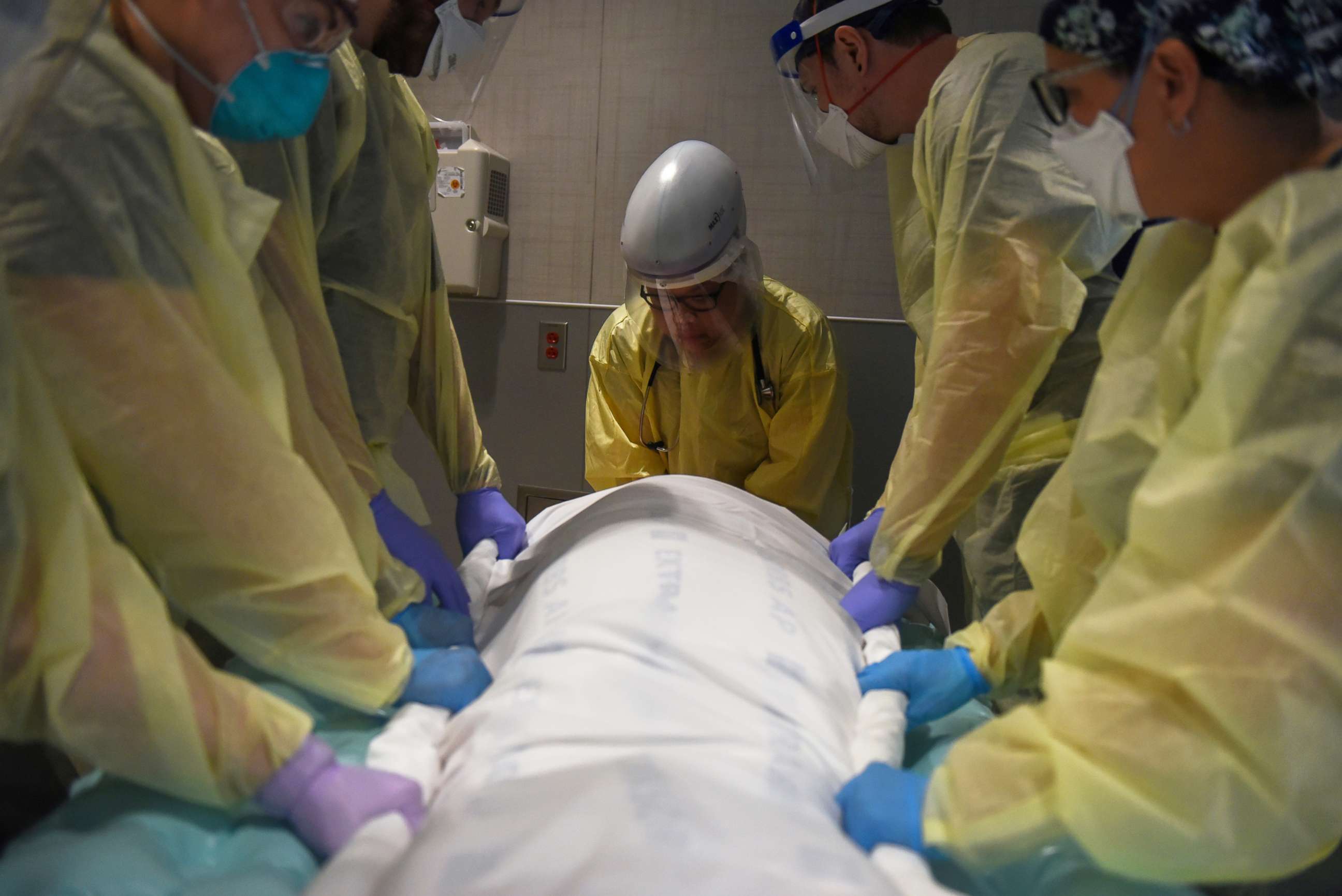 PHOTO: Healthcare personnel prepare to rotate a patient who is on a ventilator inside a room for patients with COVID-19 at a hospital in Hutchinson, Kansas, Nov. 20, 2020.