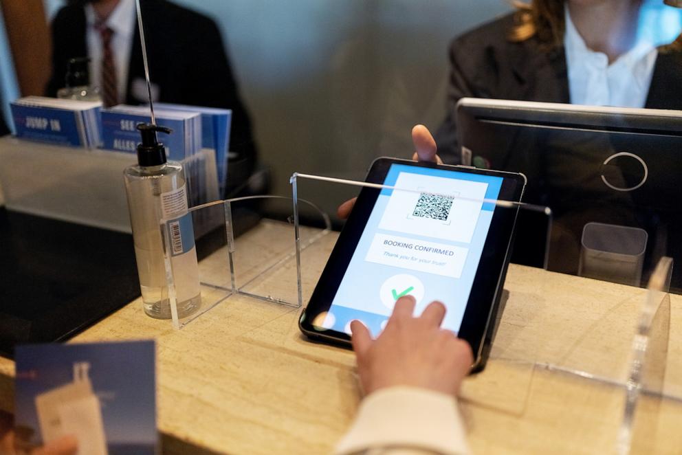 PHOTO: Stock photo of a person checking into a hotel.