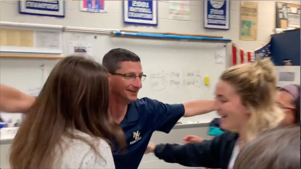 PHOTO: New Egypt High School history teacher Tom Corby hugs his students after they surprised him with tickets to see "Hamilton."