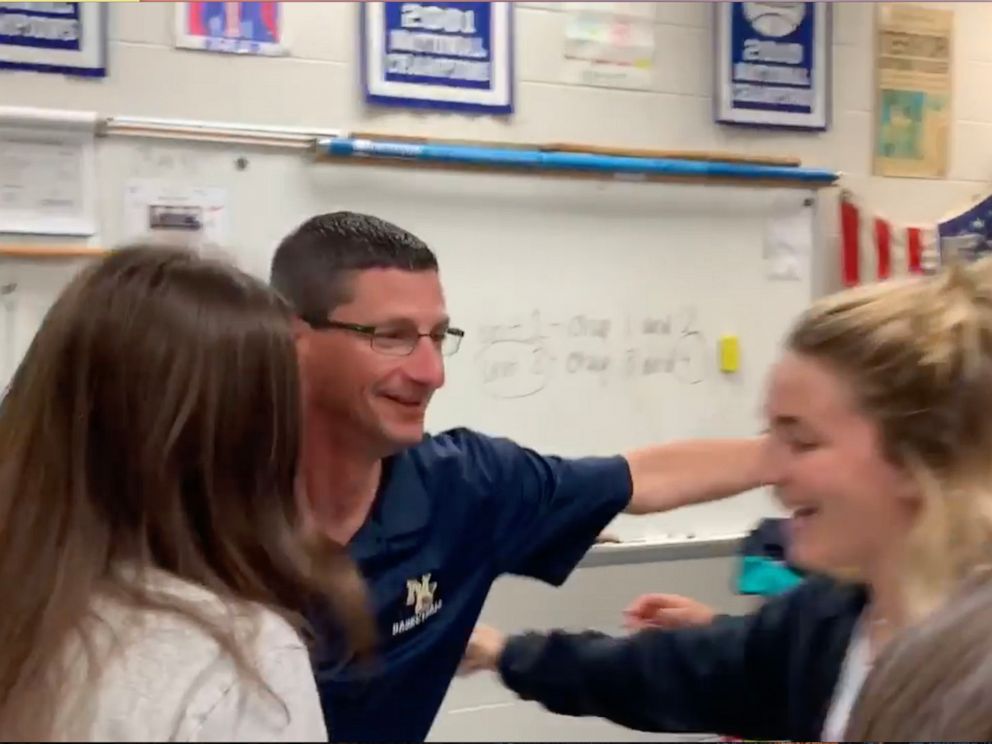 PHOTO: New Egypt High School history teacher Tom Corby hugs his students after they surprised him with tickets to see Hamilton.