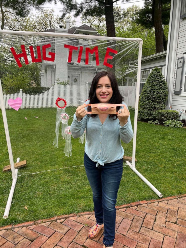 PHOTO:  'Hug Time' inventor, Carly Marinaro, pictured in front of her plastic hug shield she made from PVC pipe, a window insulator kit, and industrial gloves in Rockford, Illinois.