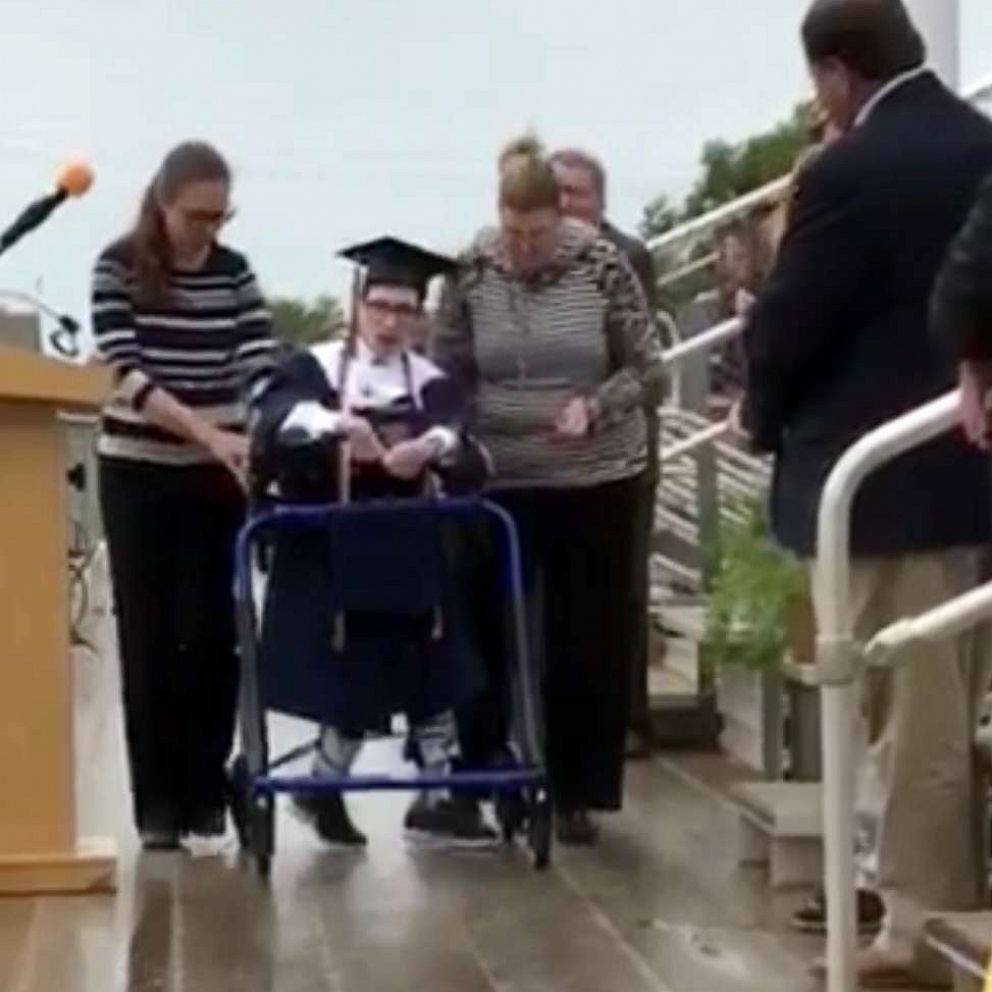 VIDEO: High school grad with cerebral palsy surprises classmates 