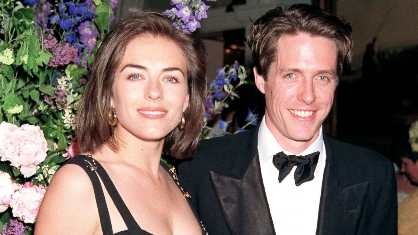 PHOTO: Elizabeth Hurley is pictured alongside Hugh Grant as she wears a Giani Versace dress to the premiere of "Four Weddings and A Funeral" held on March 09, 1994, in London.