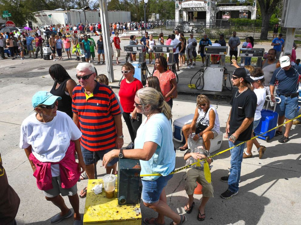 PHOTO: People waiting up to two hours in long lines in downtown Wilmington, N.C., waiting to buy ice from The Rose Ice and Coal Company on Market Street, Sept. 17, 2018.