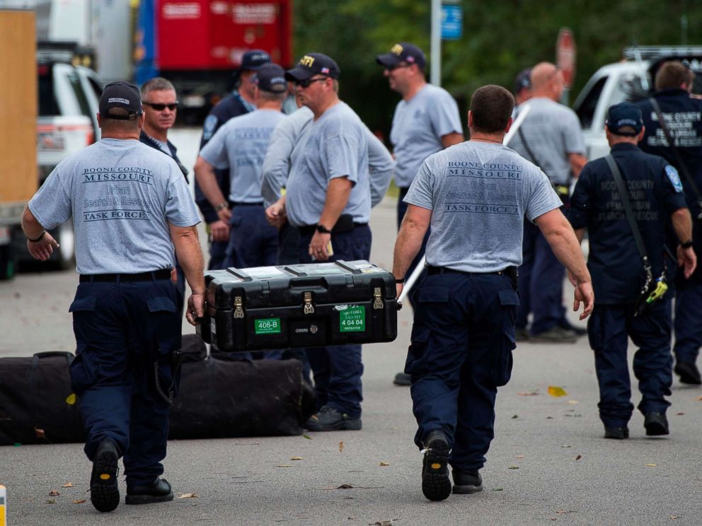 PHOTO: Members of the Missouri Searh and Rescue, part of FEMA, unload their gear at a staging area as Hurricane Florence starts to make landfall in Lealand, North Carolina on September 13, 2018.