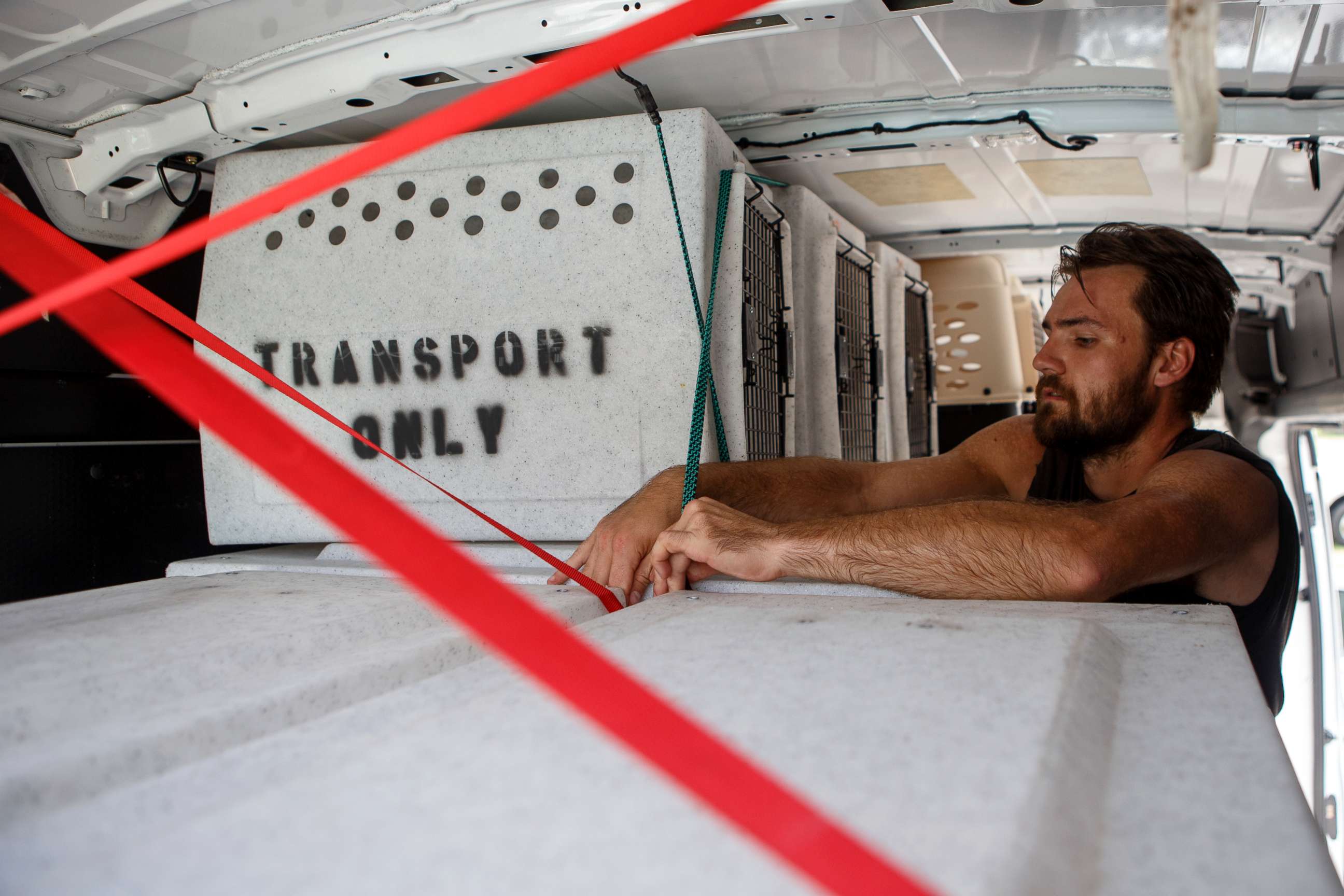 PHOTO: Evan Shepard, the lead canine behavior assessor for McKamey, works on securing kennels in a transport van at McKamey Animal Center on Sept. 12, 2018 in Chattanooga, Tenn.